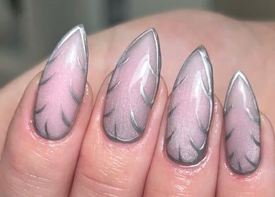 Stylish nail art at The Gellab, Wath Upon Dearne, England, GB. Delicate pink nails with intricate silver detailing.