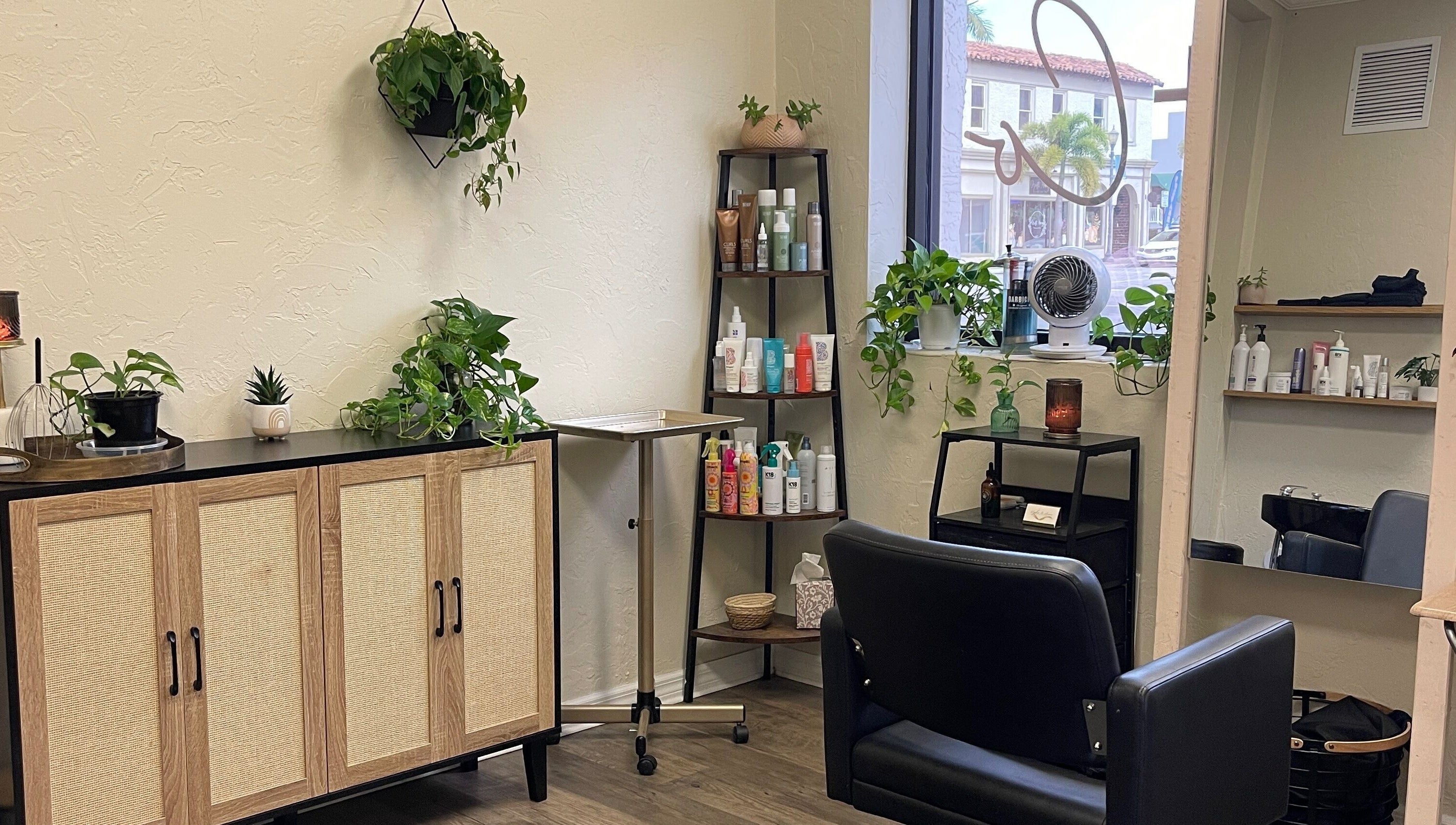 Cozy interior of Highs & Lows Hair Studio, Fort Pierce, Florida, US with plants and styling products.