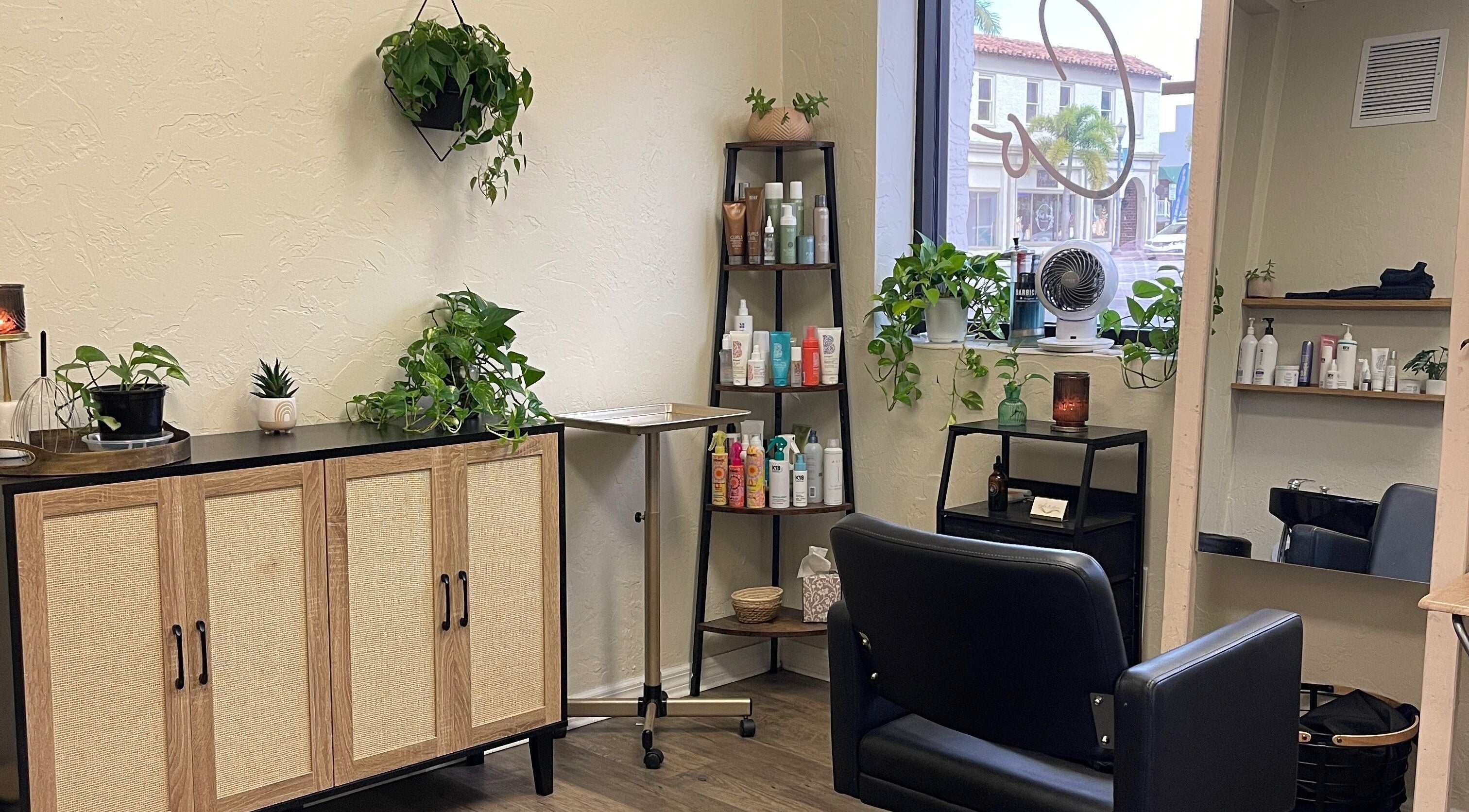 Cozy interior of Highs & Lows Hair Studio, Fort Pierce, Florida, US with plants and styling products.