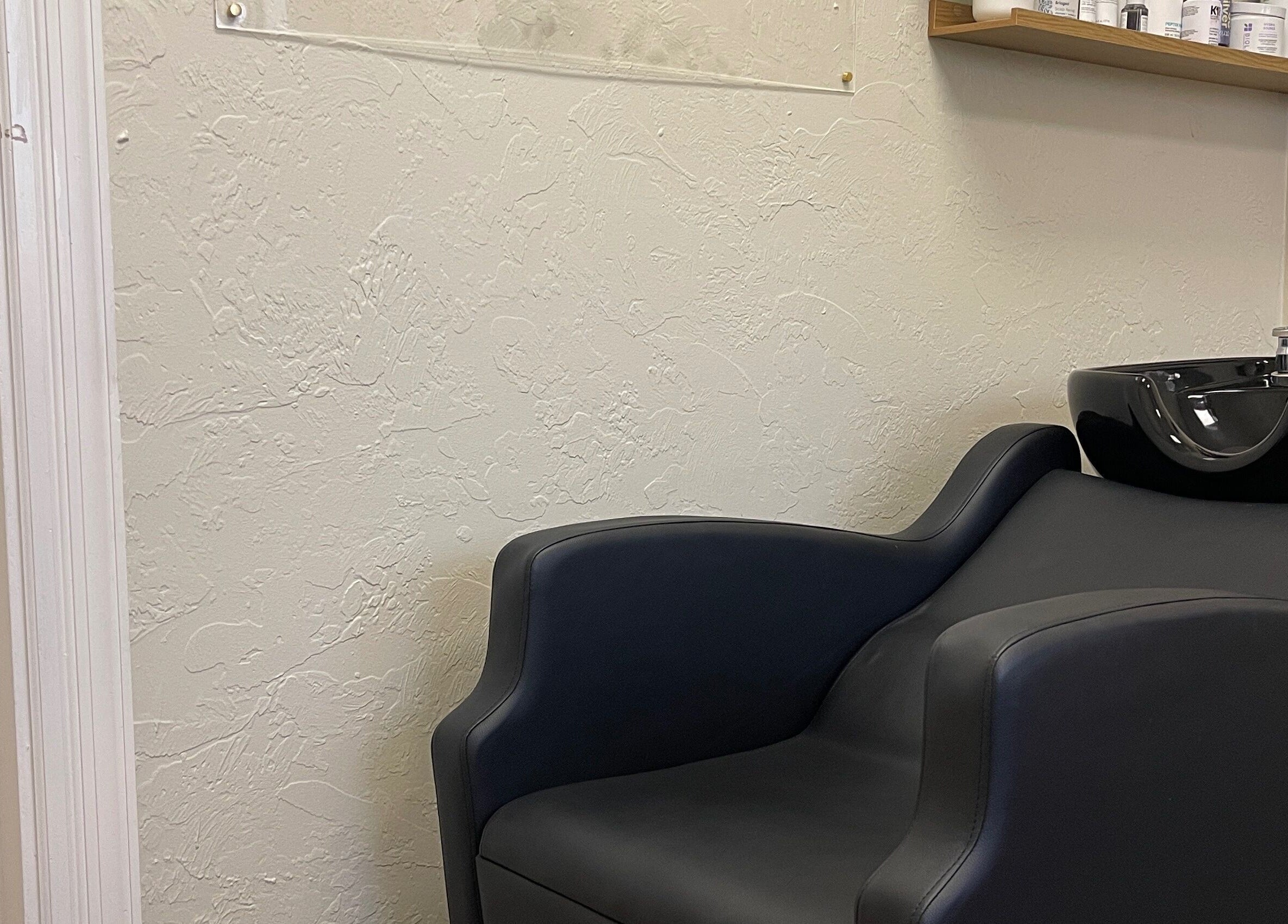 Modern wash station at Highs & Lows Hair Studio in Fort Pierce, Florida, US. Relaxing seat and stylish sink.