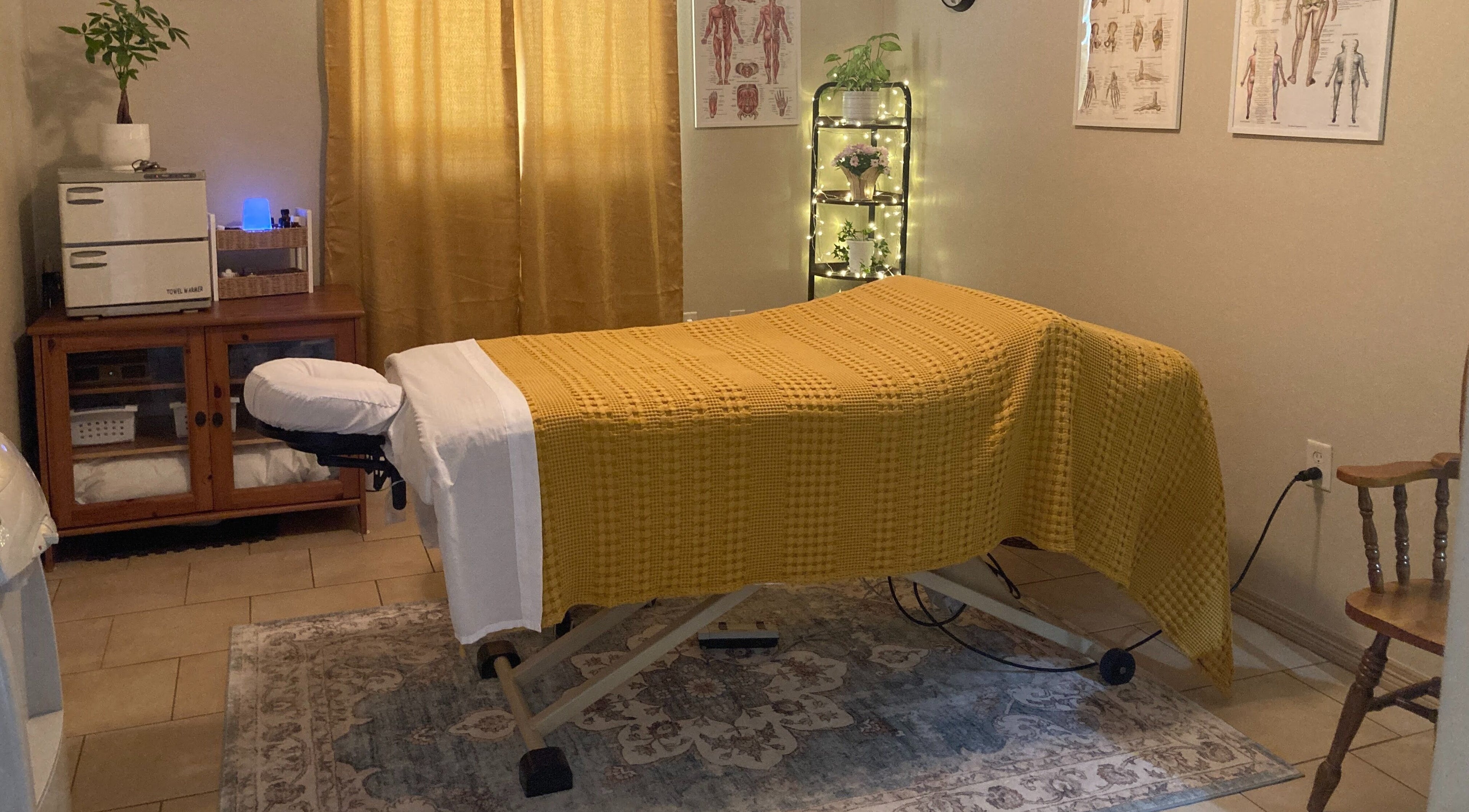 Calming massage room at Namassage Bodywork in Houston, Texas, US, with massage table and warm lighting.