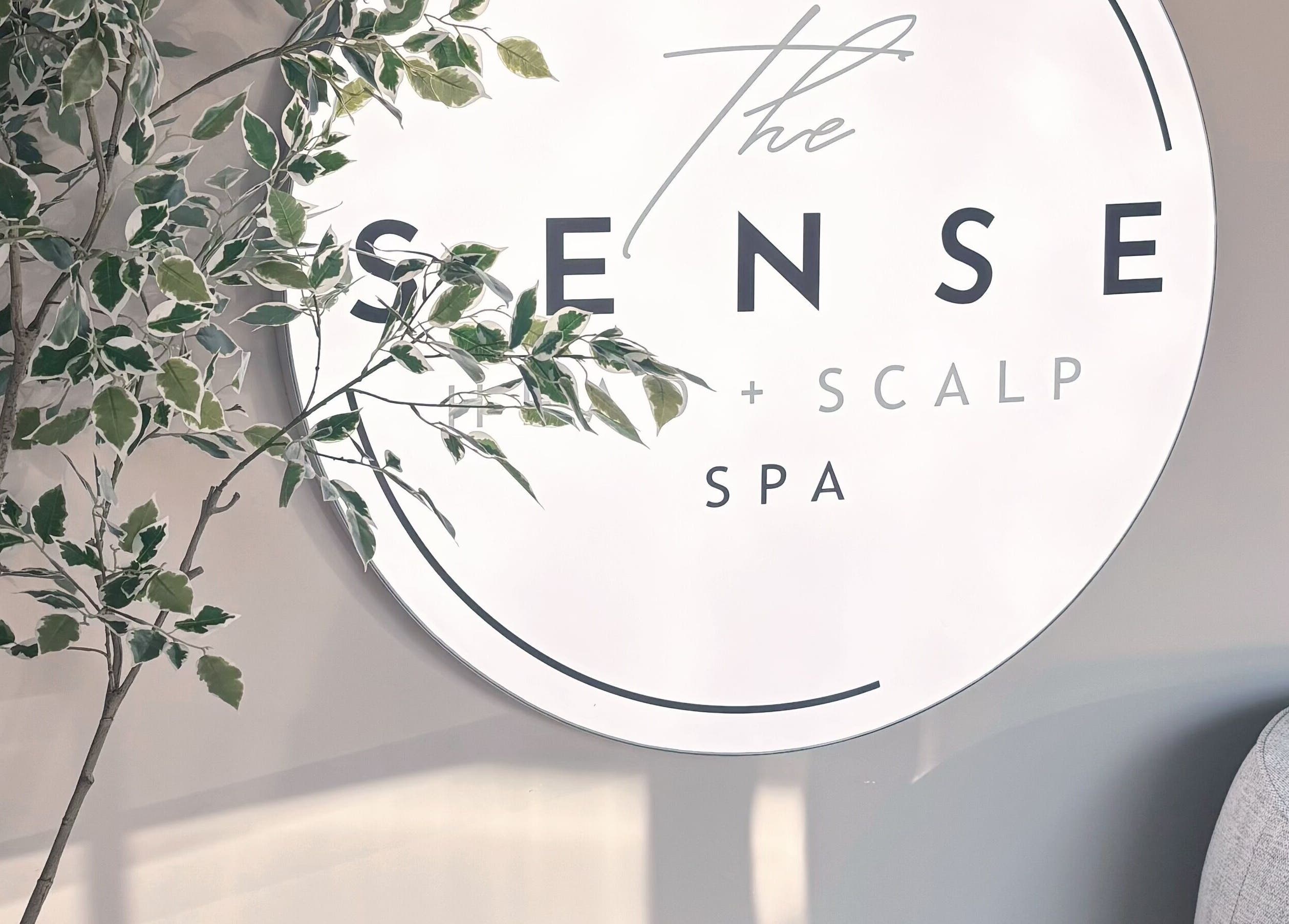 Logo sign of The Sense Head + Scalp Spa-Mountain View surrounded by greenery in Mountain View, California, US.