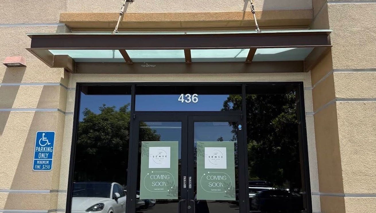 Entrance of The Sense Head + Scalp Spa- Fremont, California, US, with glass doors showing 'Coming Soon' signs.