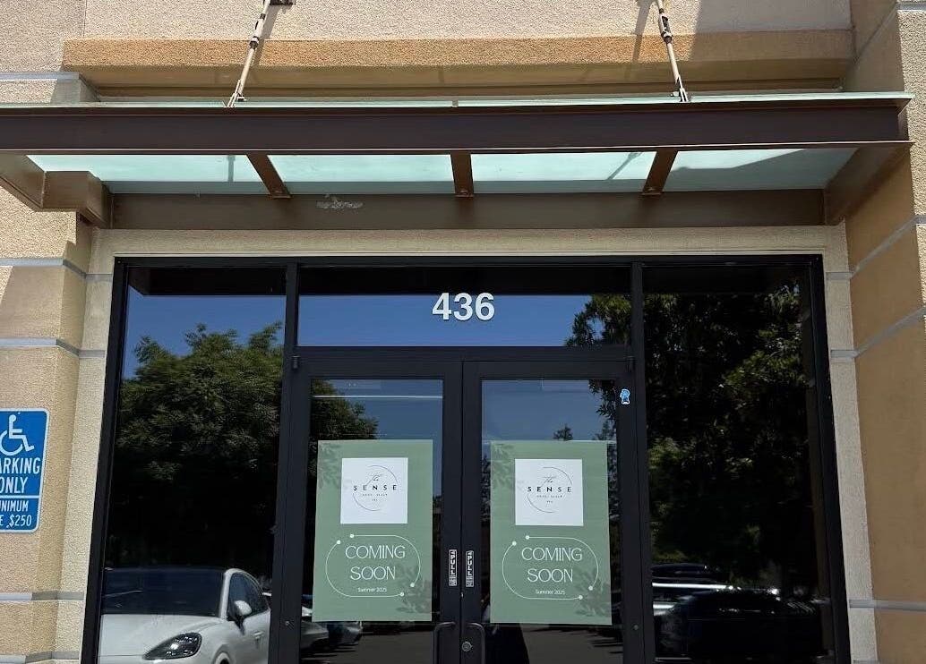 Entrance of The Sense Head + Scalp Spa- Fremont, California, US, with glass doors showing 'Coming Soon' signs.