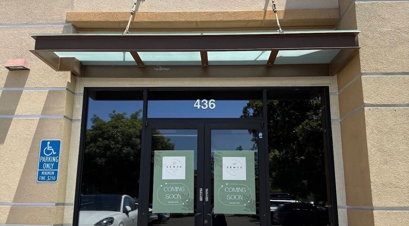 Entrance of The Sense Head + Scalp Spa- Fremont, California, US, with glass doors showing 'Coming Soon' signs.