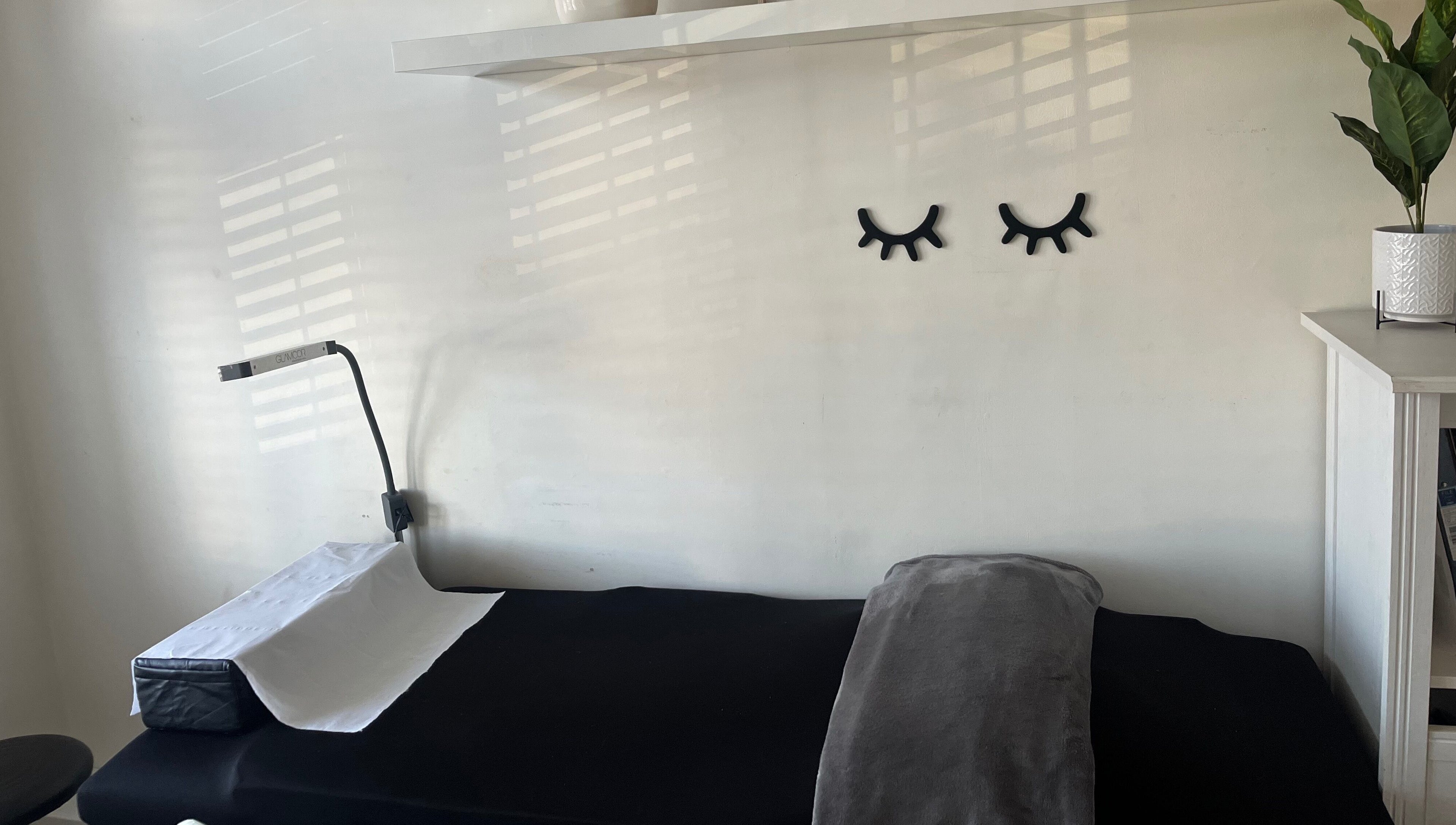 Treatment room at Lash Lovin’, London, England, GB, featuring cozy bed and modern decor.