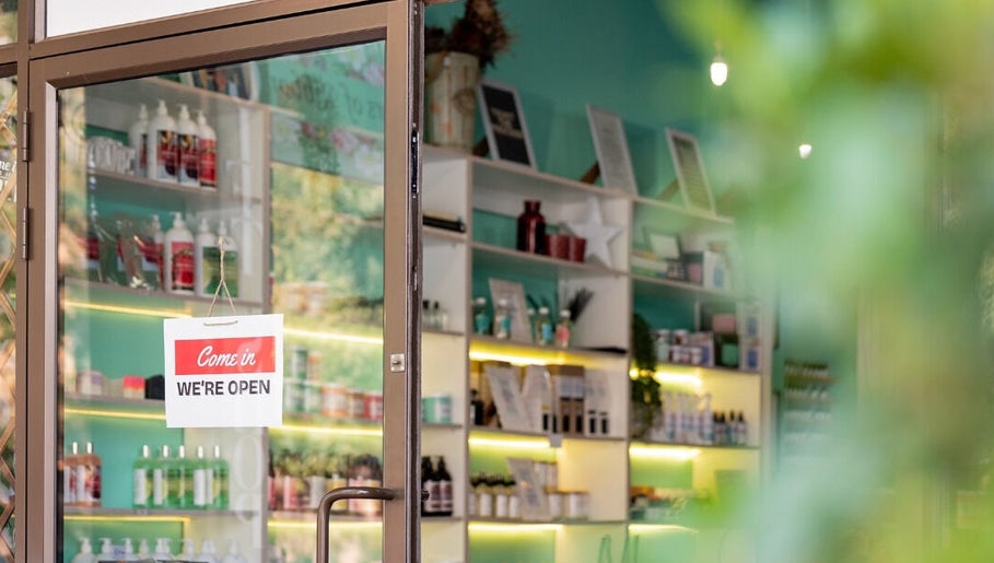 Entrance of Lemon Berry Nail Bar in Randburg, Gauteng, ZA with 'We're Open' sign and vibrant interior.