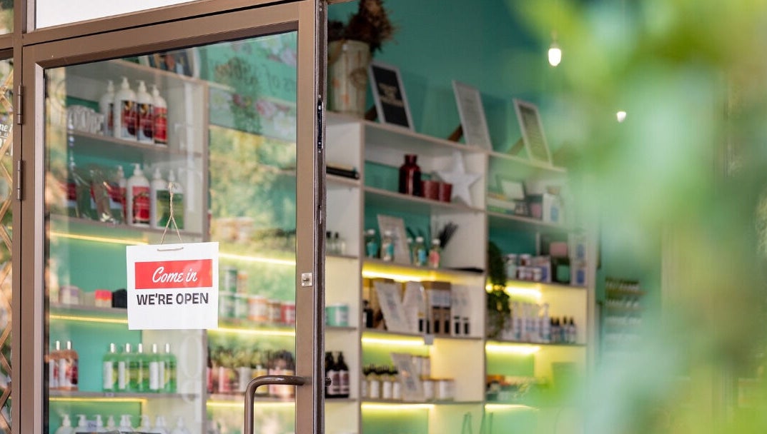 Entrance of Lemon Berry Nail Bar in Randburg, Gauteng, ZA with 'We're Open' sign and vibrant interior.