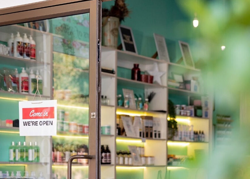 Entrance of Lemon Berry Nail Bar in Randburg, Gauteng, ZA with 'We're Open' sign and vibrant interior.