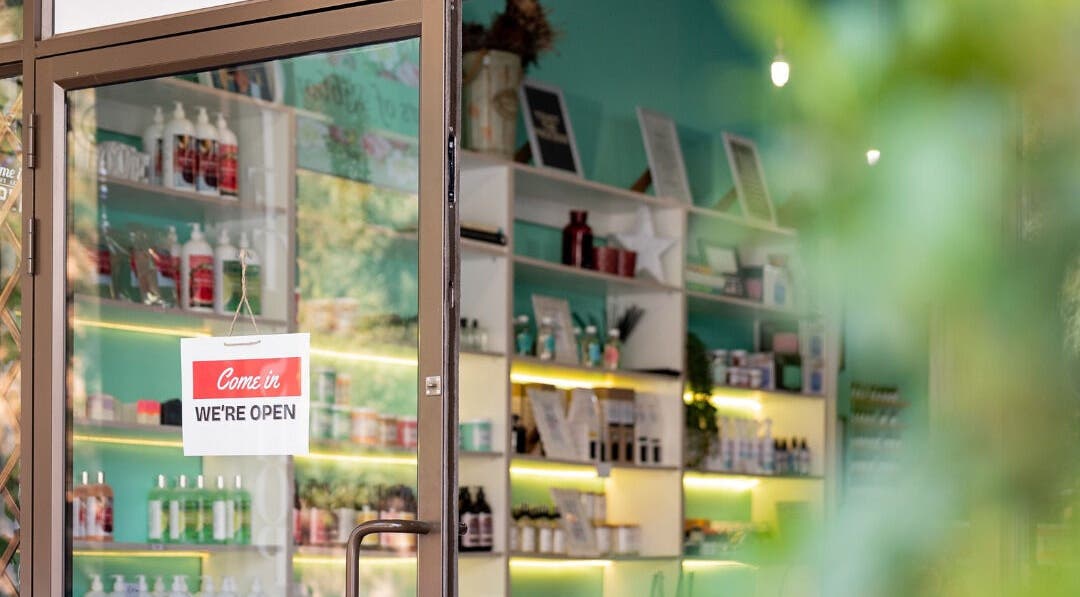 Entrance of Lemon Berry Nail Bar in Randburg, Gauteng, ZA with 'We're Open' sign and vibrant interior.
