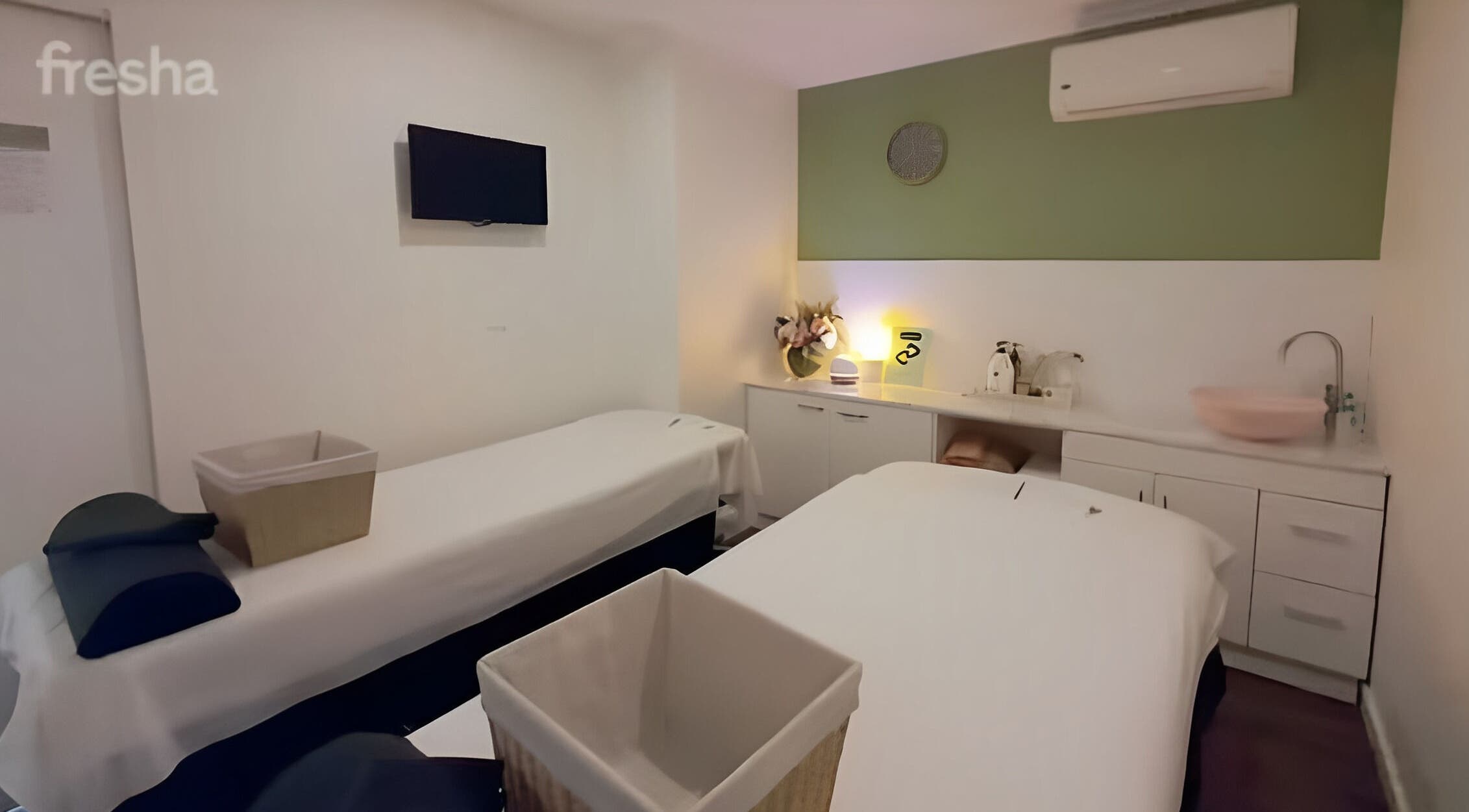 Relaxing massage room at AROKA Therapeutic Centre in Hamilton, Queensland, AU, featuring two massage tables.