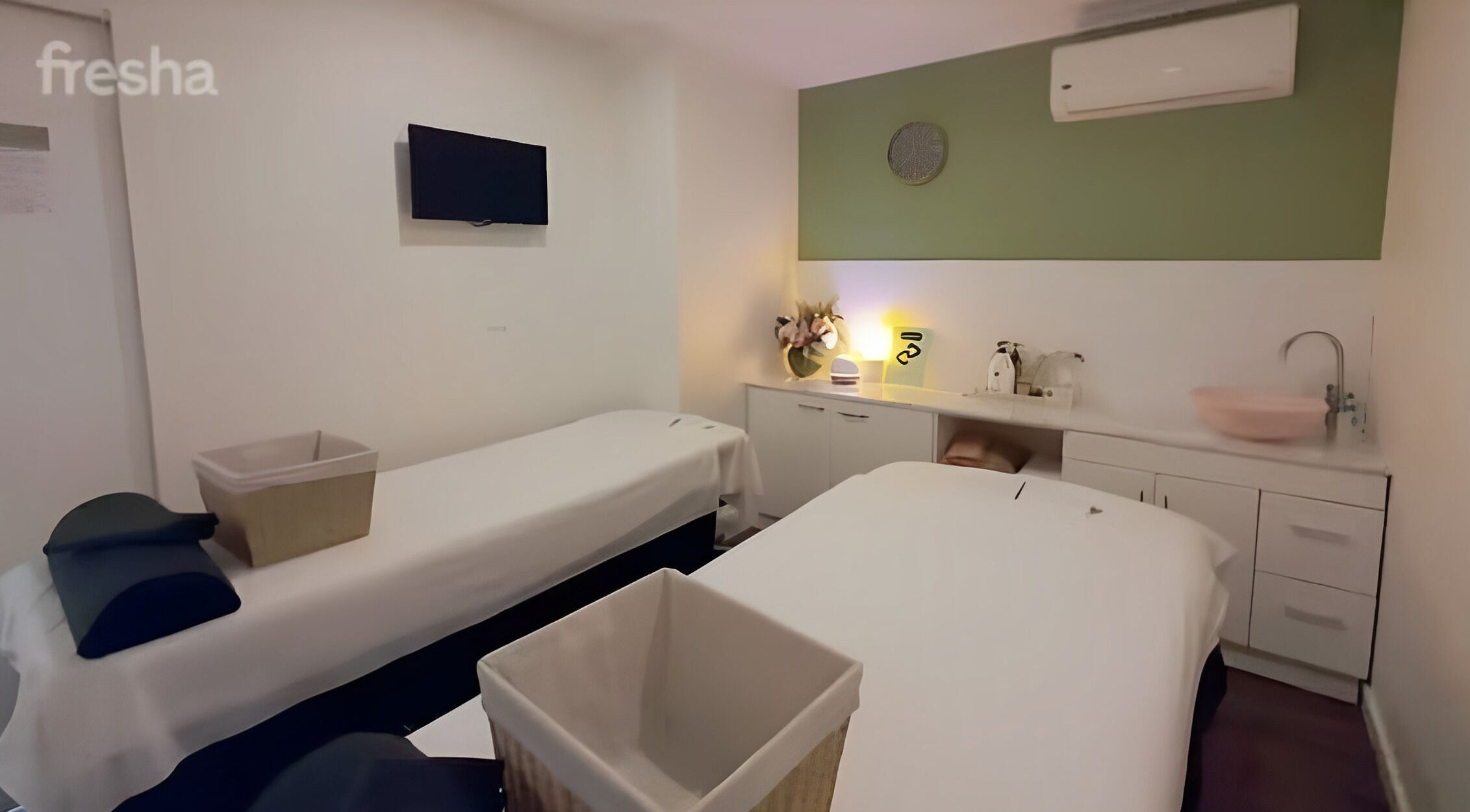 Relaxing massage room at AROKA Therapeutic Centre in Hamilton, Queensland, AU, featuring two massage tables.