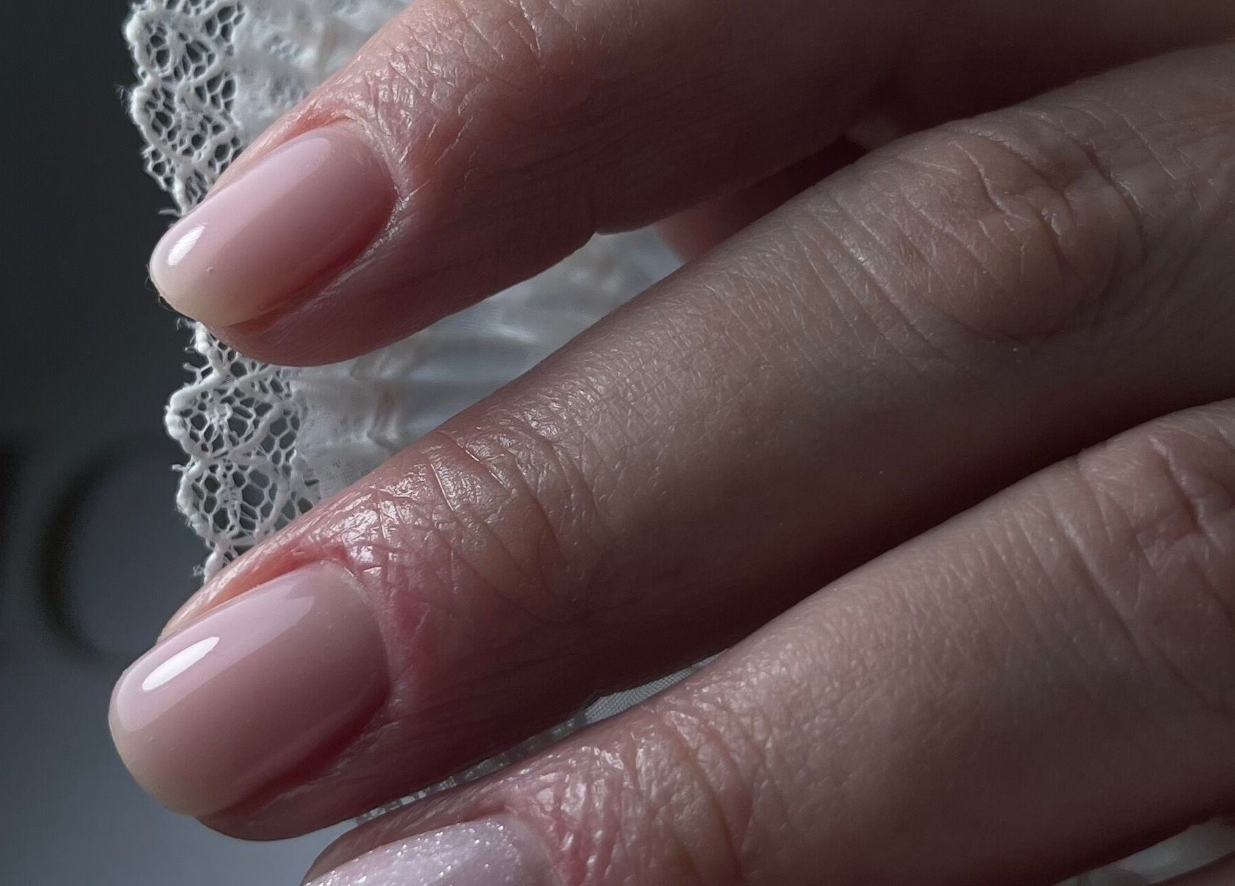 Close-up of a stylish manicure at n.15Studio, Addlestone, England, GB, showcasing glossy nude nails.