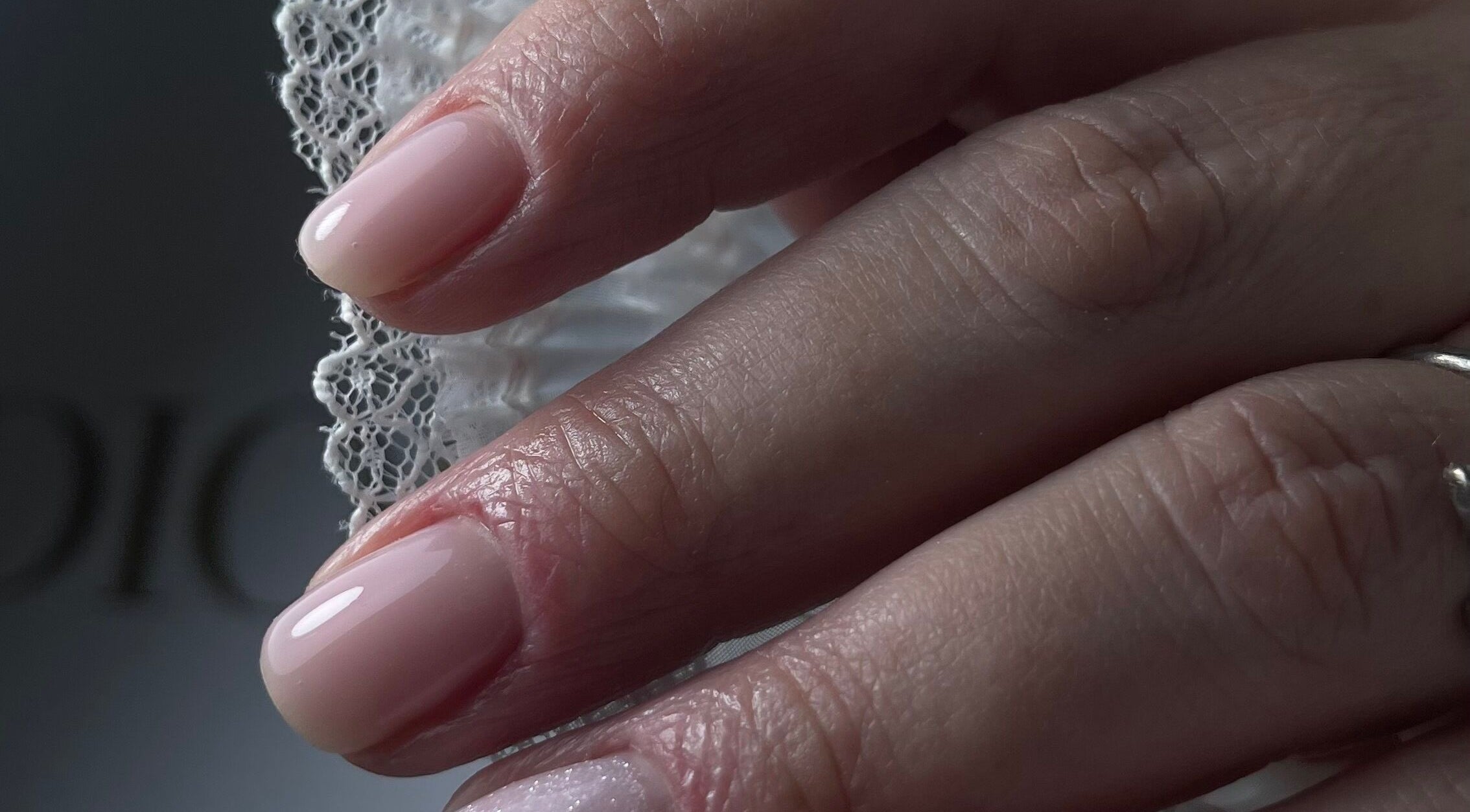 Close-up of a stylish manicure at n.15Studio, Addlestone, England, GB, showcasing glossy nude nails.