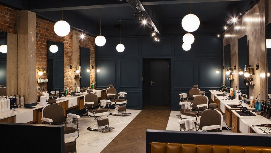 Interior of Hermanos Barbershop Loop Street in Cape Town, Western Cape, ZA showcasing modern barber chairs and decor.