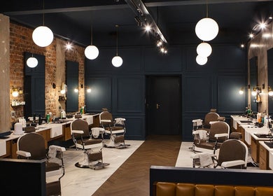 Interior of Hermanos Barbershop Loop Street in Cape Town, Western Cape, ZA showcasing modern barber chairs and decor.