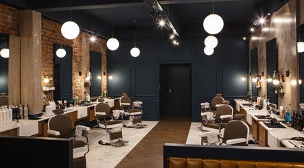 Interior of Hermanos Barbershop Loop Street in Cape Town, Western Cape, ZA showcasing modern barber chairs and decor.