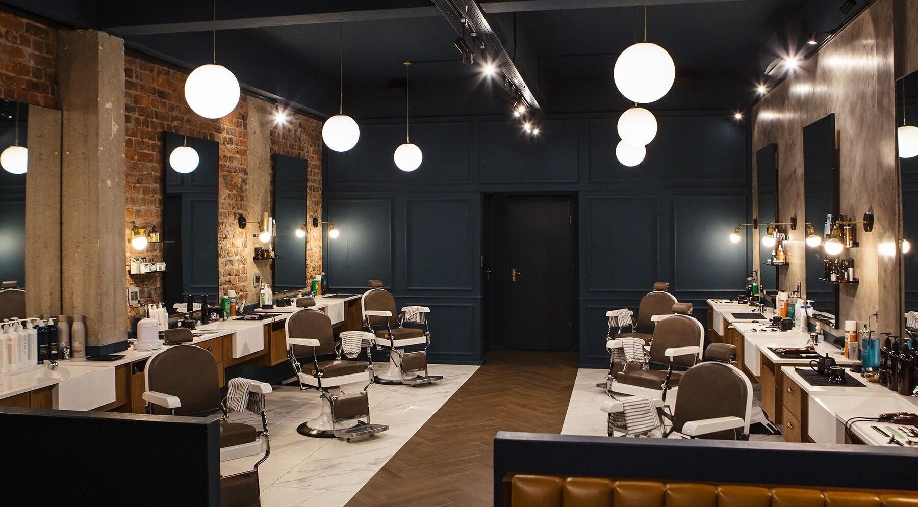 Interior of Hermanos Barbershop Loop Street in Cape Town, Western Cape, ZA showcasing modern barber chairs and decor.