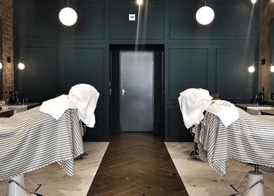 Elegant interior of Hermanos Barbershop Loop Street, Cape Town, Western Cape, ZA with barber chairs.