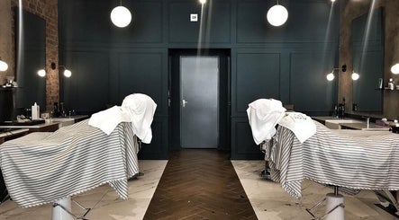 Elegant interior of Hermanos Barbershop Loop Street, Cape Town, Western Cape, ZA with barber chairs.