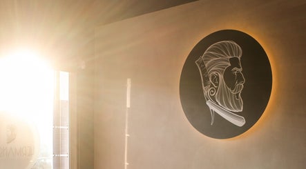 Sunlit wall art of barber at Hermanos Barbershop Green Point, Cape Town, Western Cape, ZA.