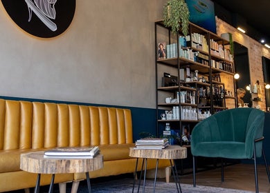 Stylish waiting area at Hermanos Barbershop Green Point, Cape Town, Western Cape, ZA.
