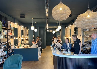 Modern interior of Hermanos Barbershop Green Point in Cape Town, Western Cape, ZA showcasing sleek design and services.