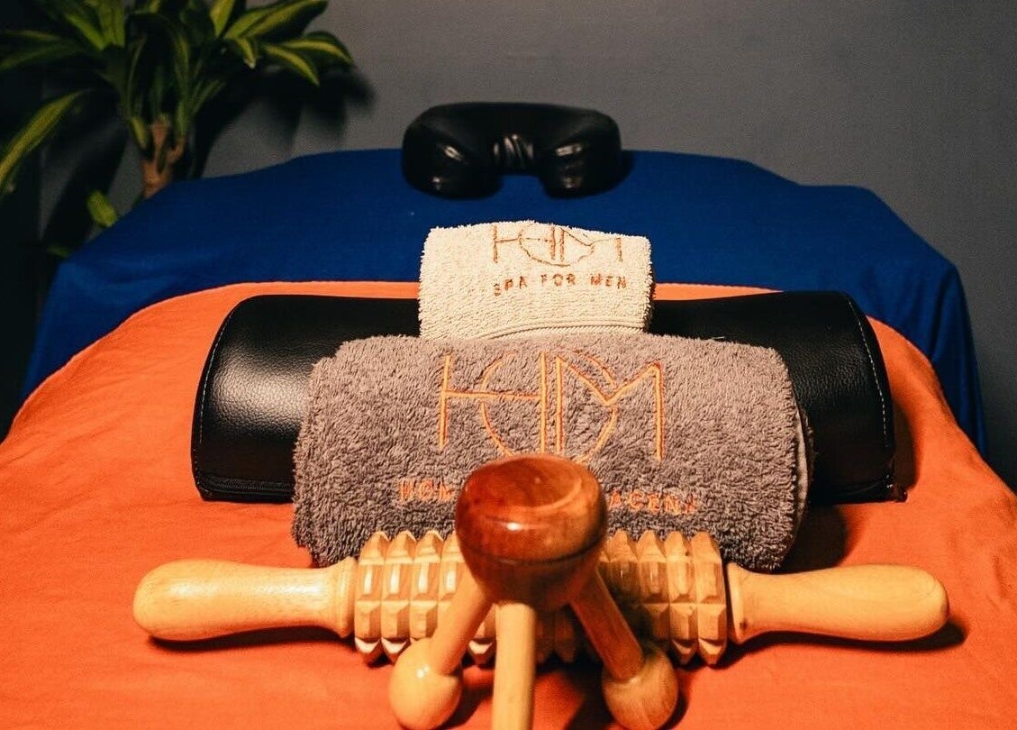 Luxurious massage setup at Hom Spa Cartagena, Cartagena, Bolívar, CO, featuring elegant towels and wooden massager.