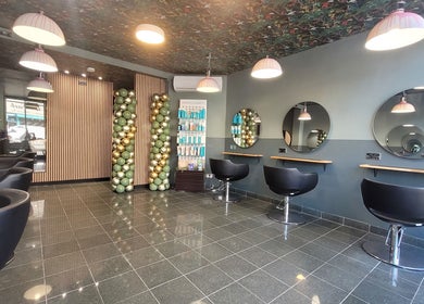 Modern salon interior at Carly at Artistic Hair Co. in Bristol, England, GB with stylish seating and decor.
