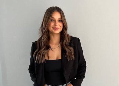 Stylish woman with long hair and black blazer at Envy Hair Company, Fort Pierce, Florida, US.