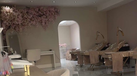 Chic interior of By Cait in North Shields, England, GB with plush chairs and blossom decor.