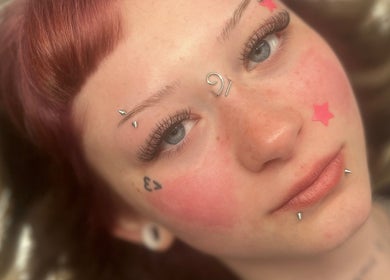 Close-up of creative facial piercings and tattoos at By Cait in North Shields, England, GB.