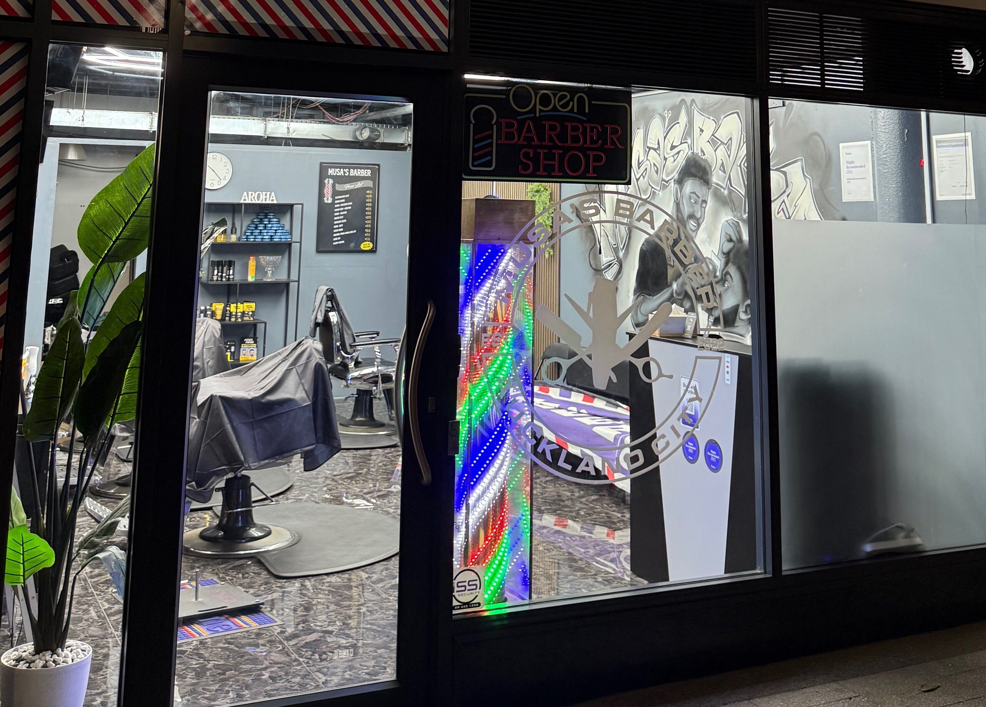 Exterior of Musa’s Barber Auckland at night, showcasing vibrant interiors in Auckland, Auckland, NZ.