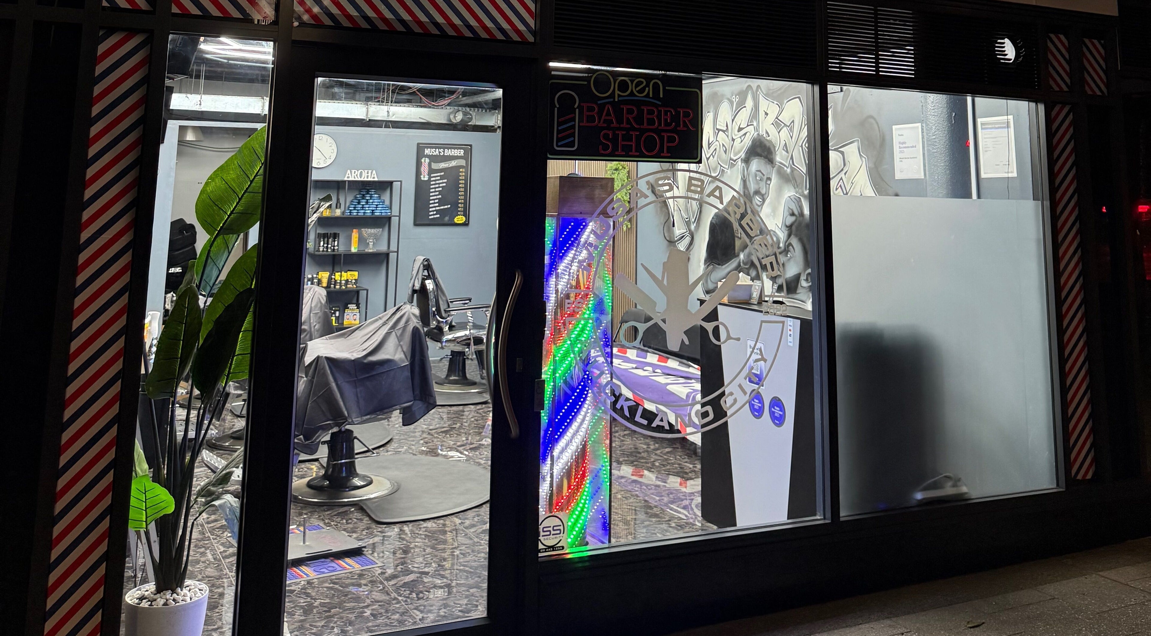 Exterior of Musa’s Barber Auckland at night, showcasing vibrant interiors in Auckland, Auckland, NZ.