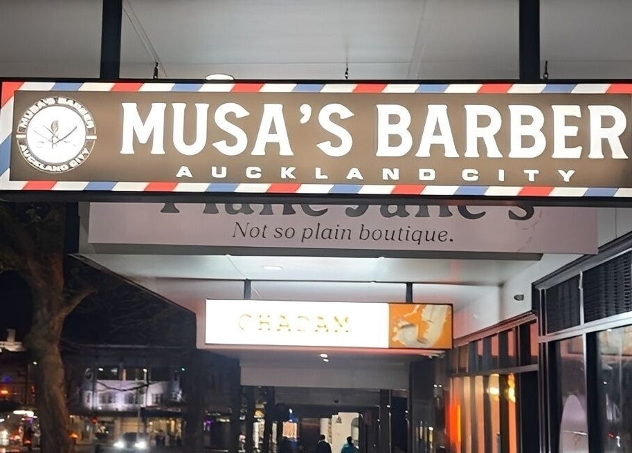 Illuminated Musa’s Barber Auckland sign at night, located in Auckland, Auckland, NZ.