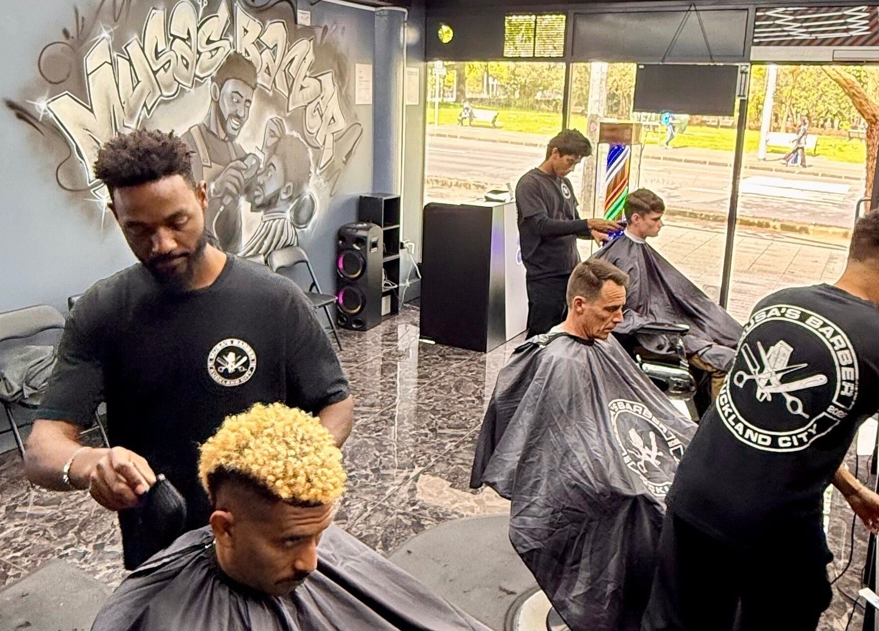 Professional barbers styling hair at Musa’s Barber Auckland, located in Auckland, NZ.