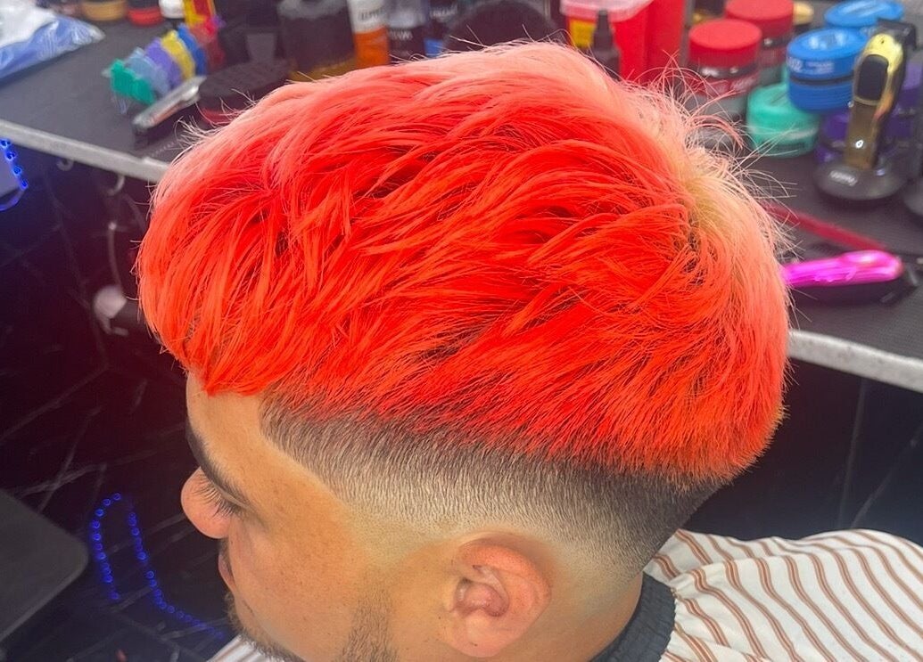 Bright red haircut at Musa’s Barber Auckland, showcasing unique style in Auckland, Auckland, NZ.