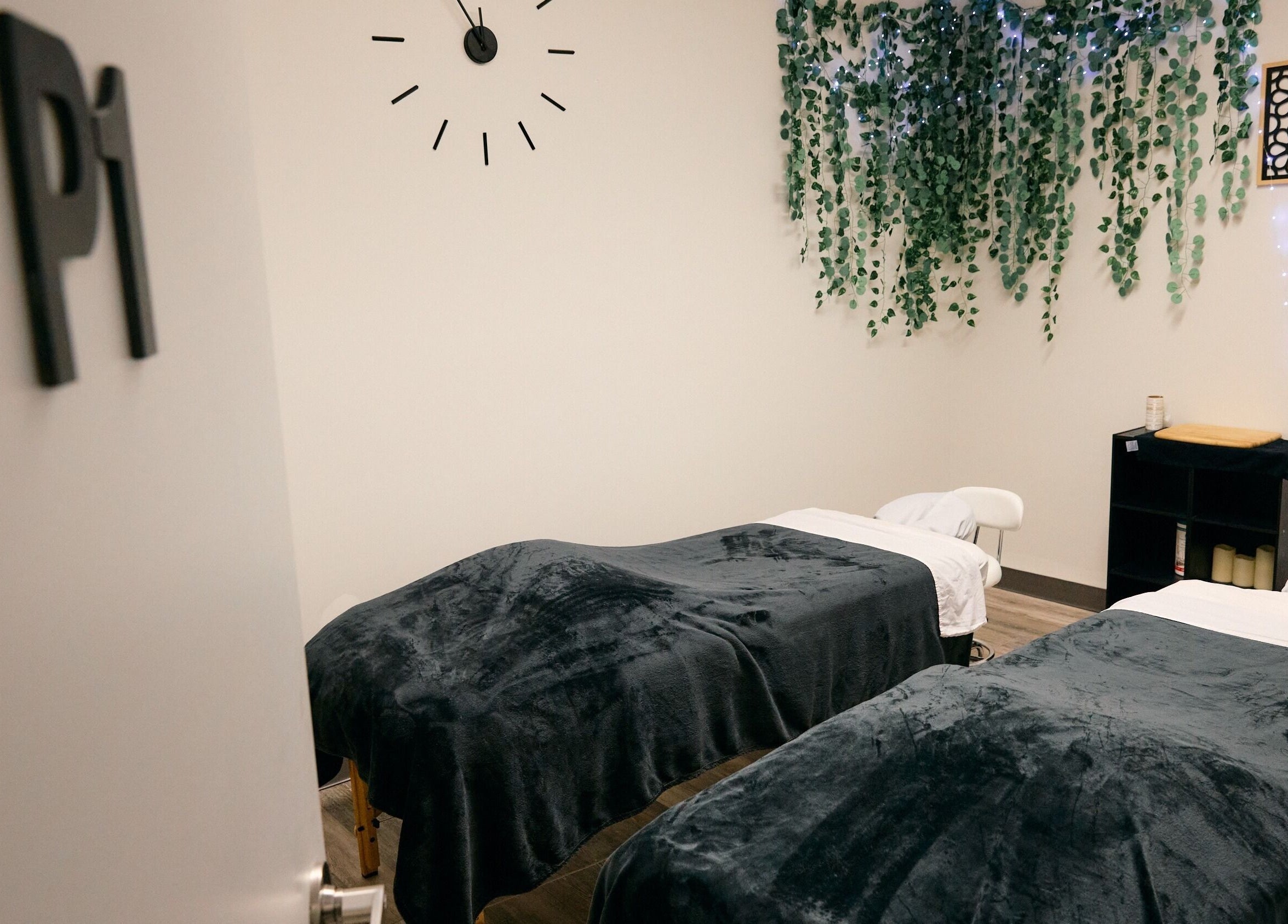 Cozy massage room at Salt and Stone Massage Therapy, Saskatoon, Saskatchewan, CA, featuring twin massage tables.