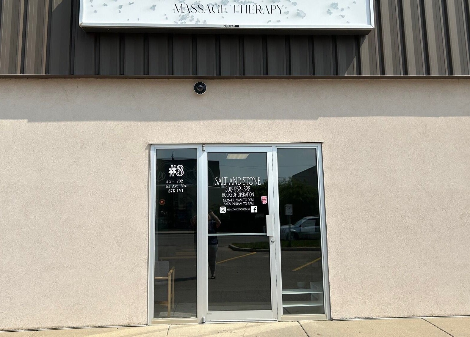 Entrance of Salt and Stone Massage Therapy in Saskatoon, Saskatchewan, CA, with welcoming glass doors.