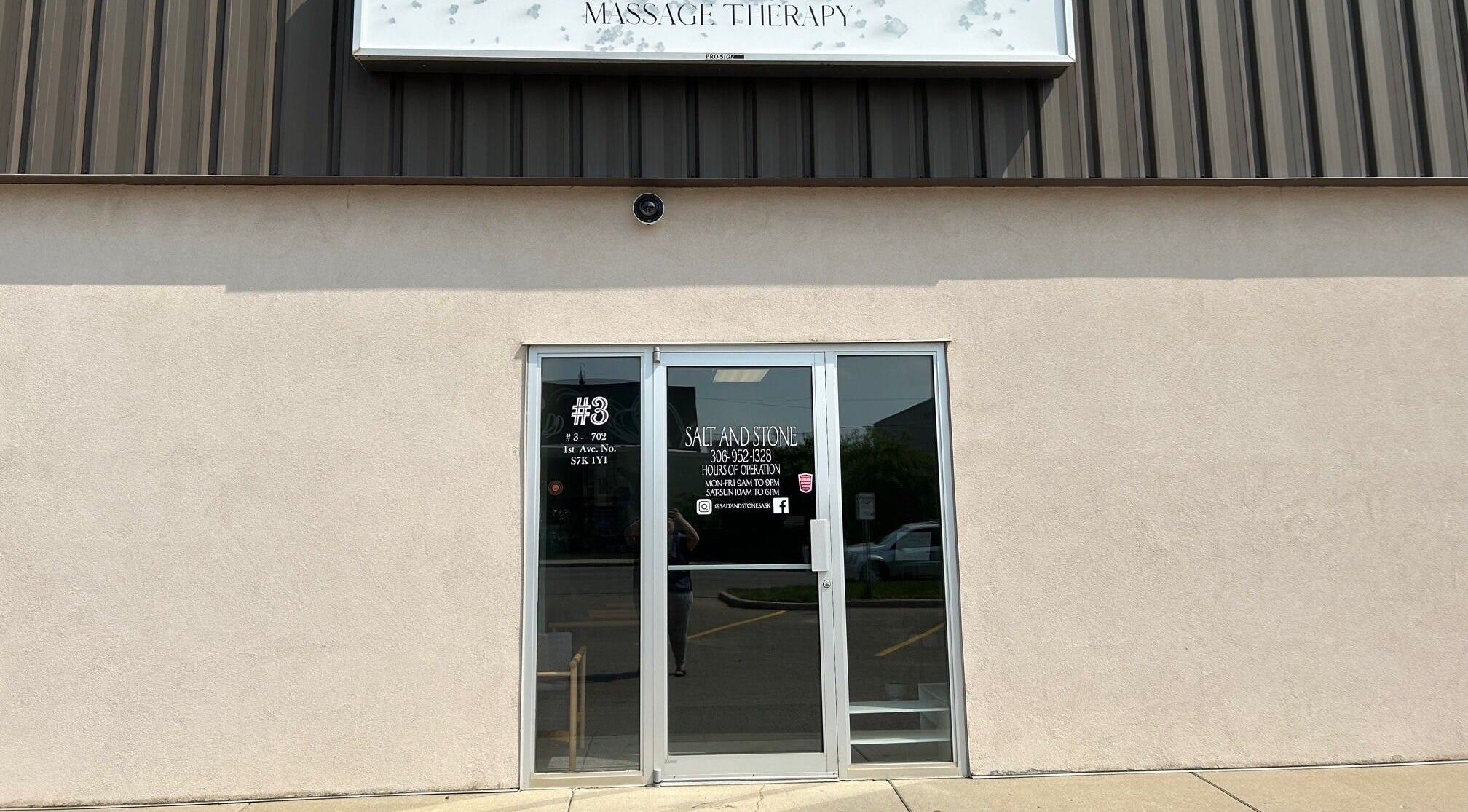 Entrance of Salt and Stone Massage Therapy in Saskatoon, Saskatchewan, CA, with welcoming glass doors.