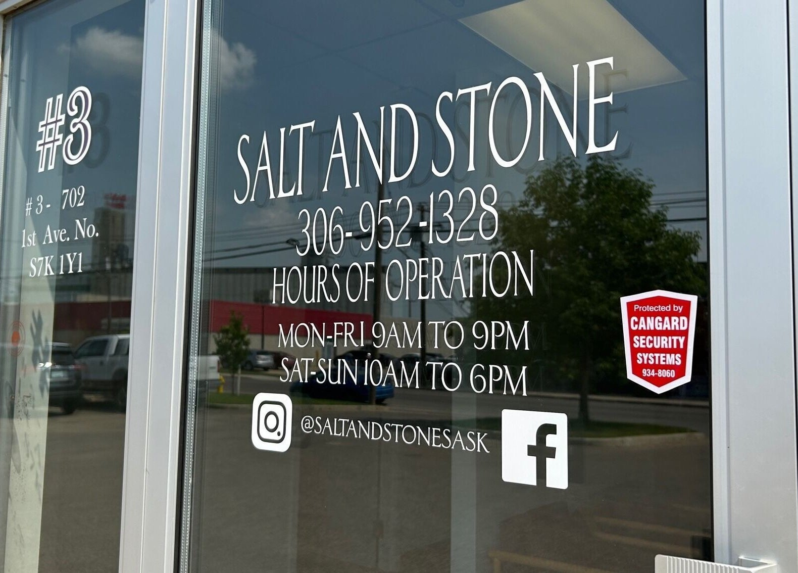 Entrance door of Salt and Stone Massage Therapy in Saskatoon, Saskatchewan, CA displaying contact info.