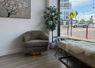 Comfortable seating area at The Brow Design Co, Bentleigh East, Victoria, AU, featuring plush chairs and natural decor.