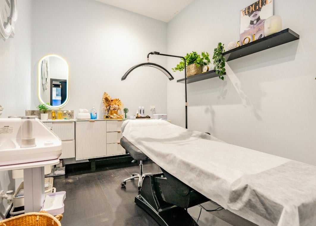Relaxing treatment room at Sol Brow and Lash, Melbourne, Victoria, AU, featuring a cozy therapy bed and wall plants.