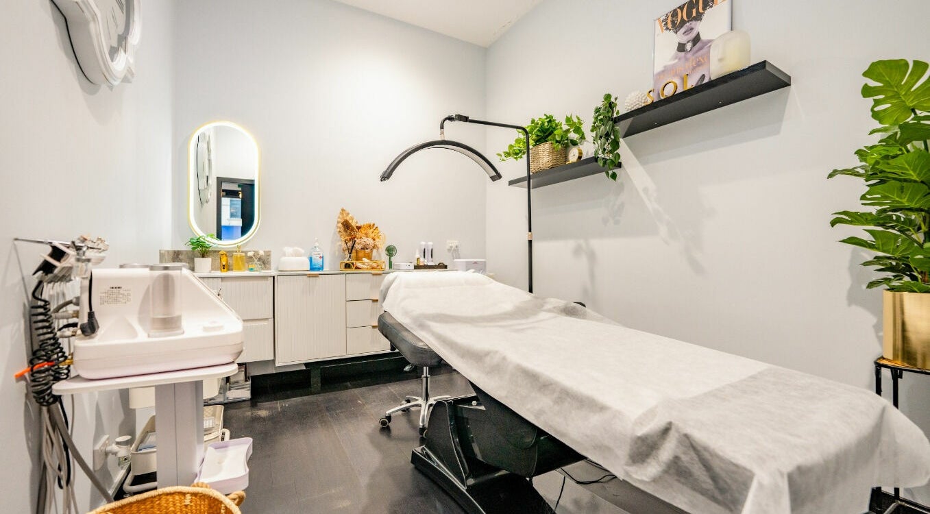 Relaxing treatment room at Sol Brow and Lash, Melbourne, Victoria, AU, featuring a cozy therapy bed and wall plants.