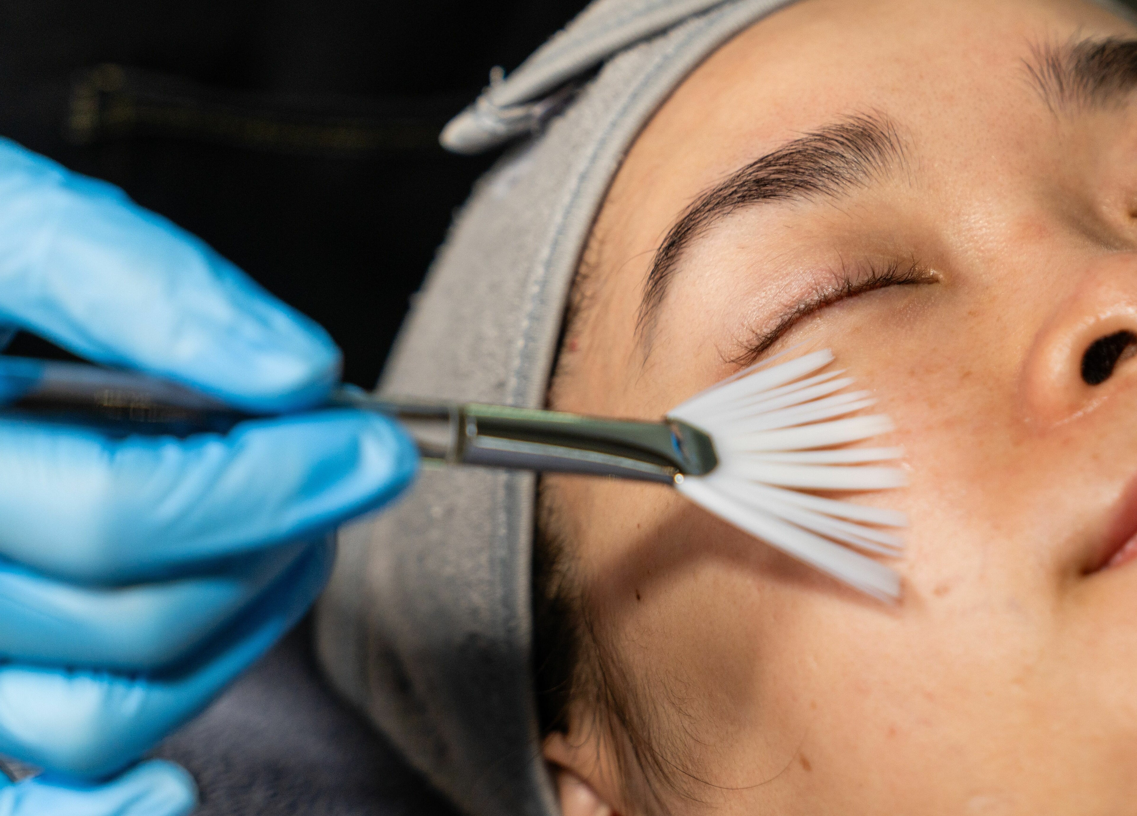 Client receiving a facial treatment with brush at Sol Brow and Lash, Melbourne, Victoria, AU.