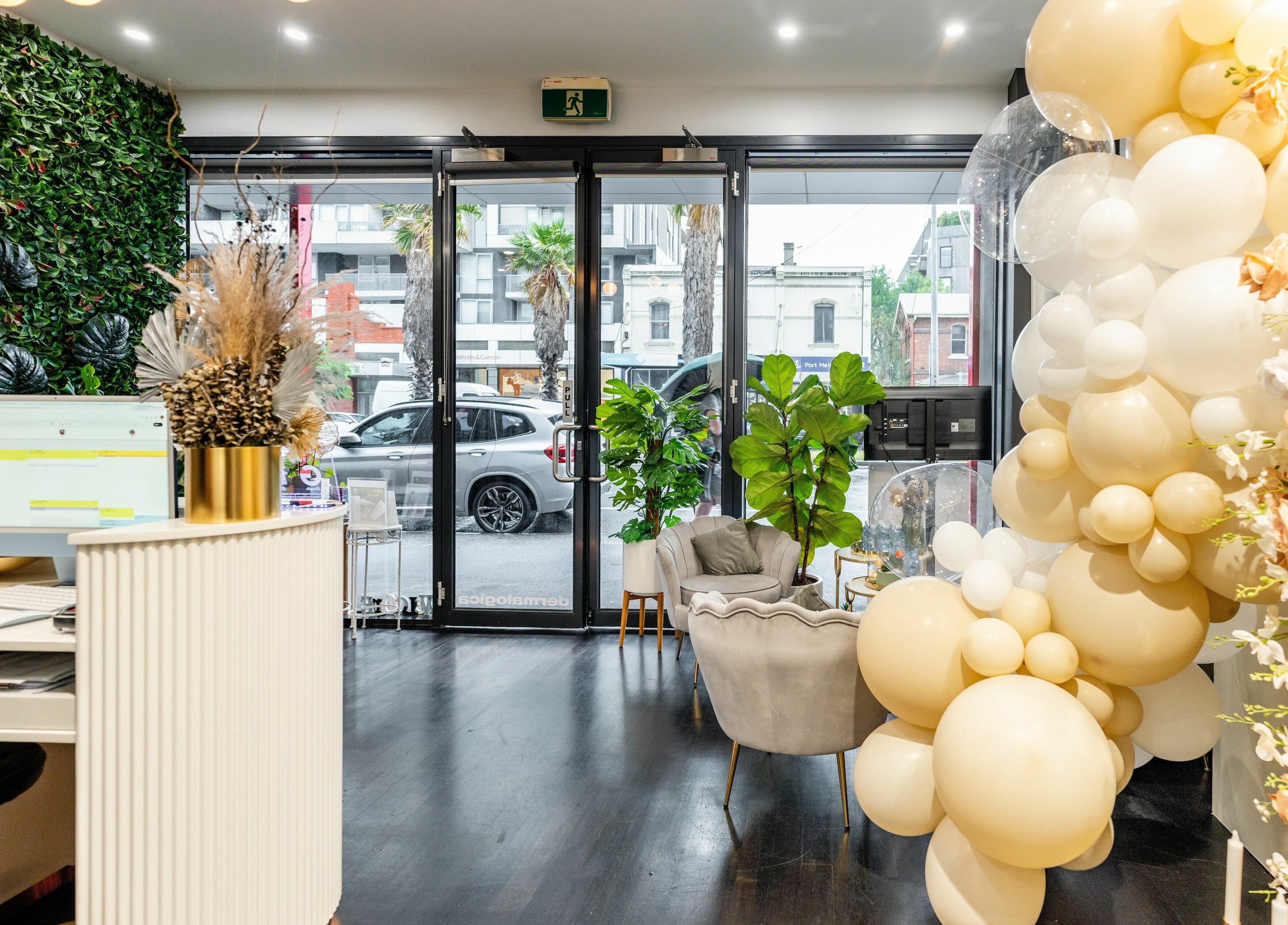 Elegant lobby of Sol Brow and Lash, Melbourne, Victoria, AU, with plush seating and floral decor.