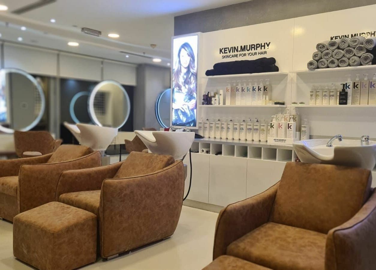 Luxurious salon chairs at Grafton Salon in Dubai, AE with premium hair care products on display.