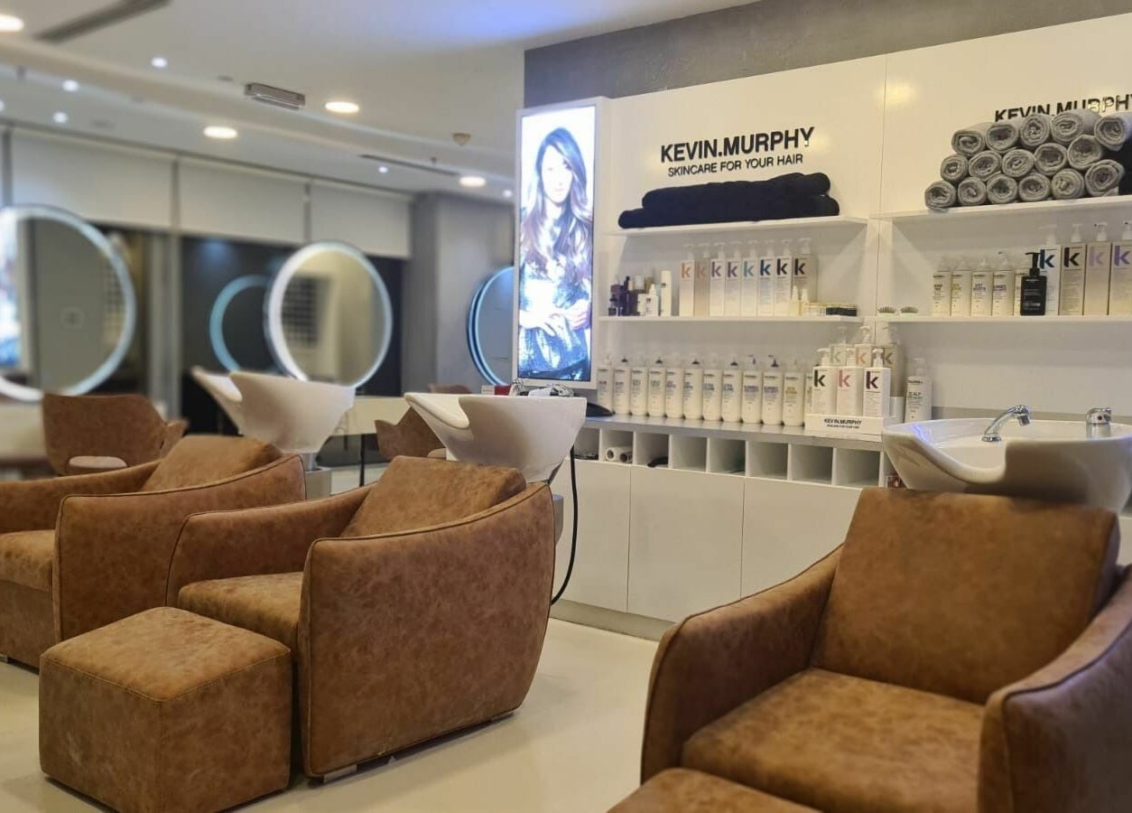 Luxurious salon chairs at Grafton Salon in Dubai, AE with premium hair care products on display.