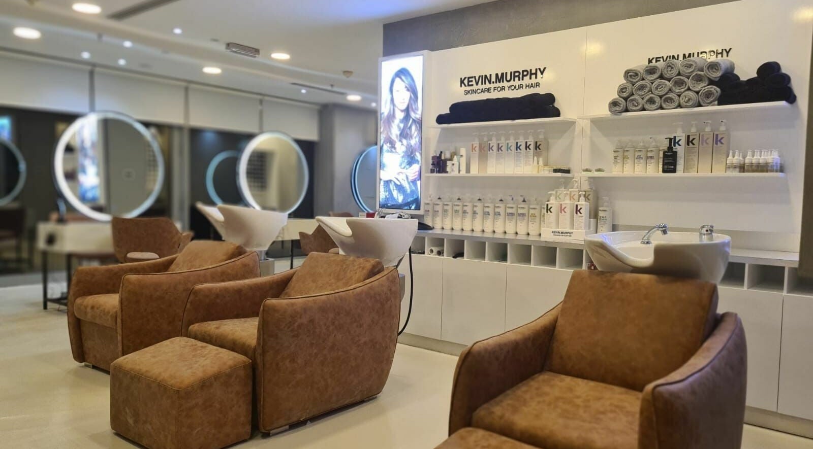 Luxurious salon chairs at Grafton Salon in Dubai, AE with premium hair care products on display.