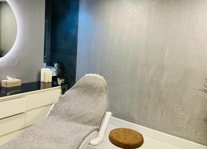 Relaxing treatment room at Grafton Salon in Dubai, AE, with cozy chair and ambient lighting.